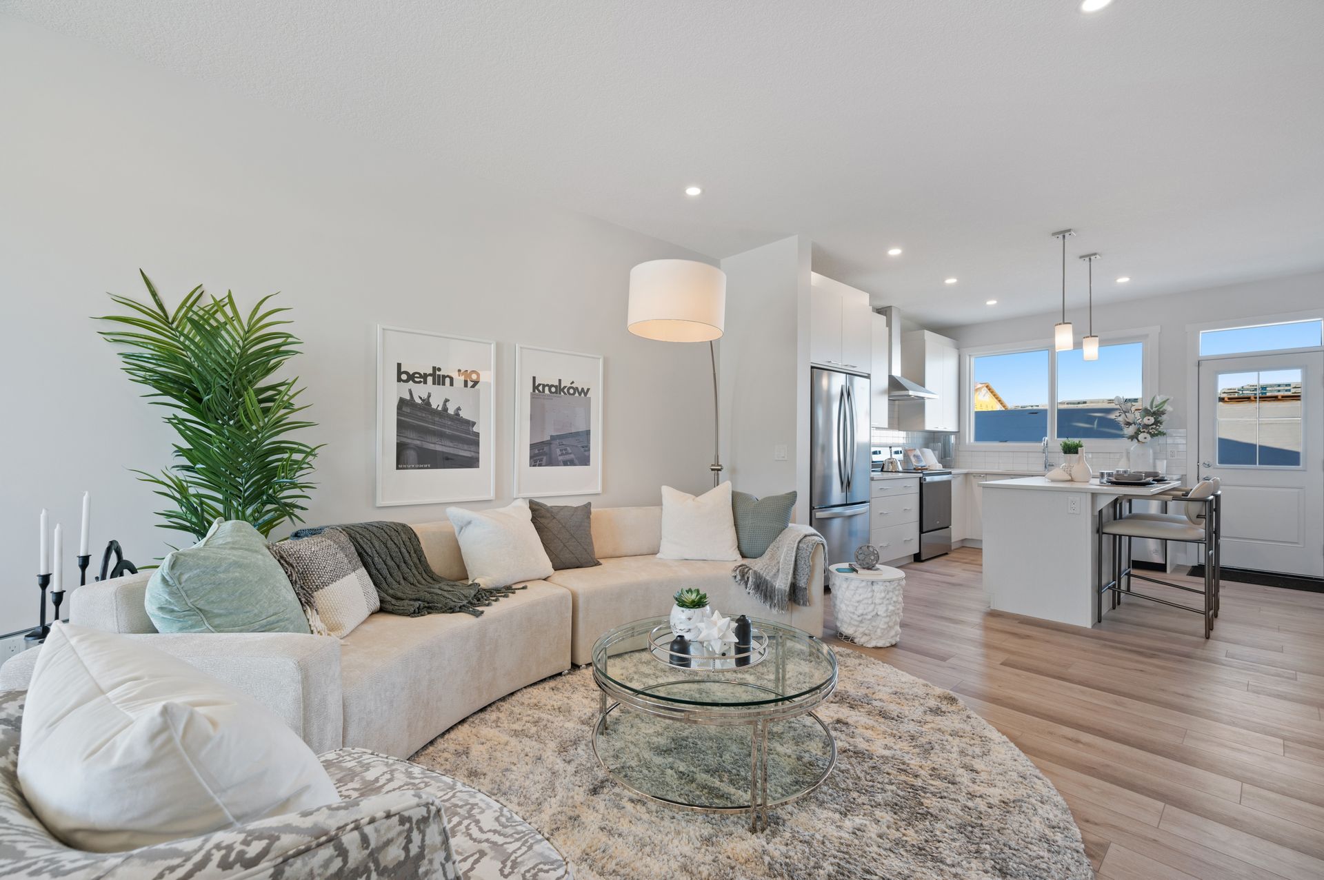Bright open-concept living room and kitchen in a Sage Hill duplex
