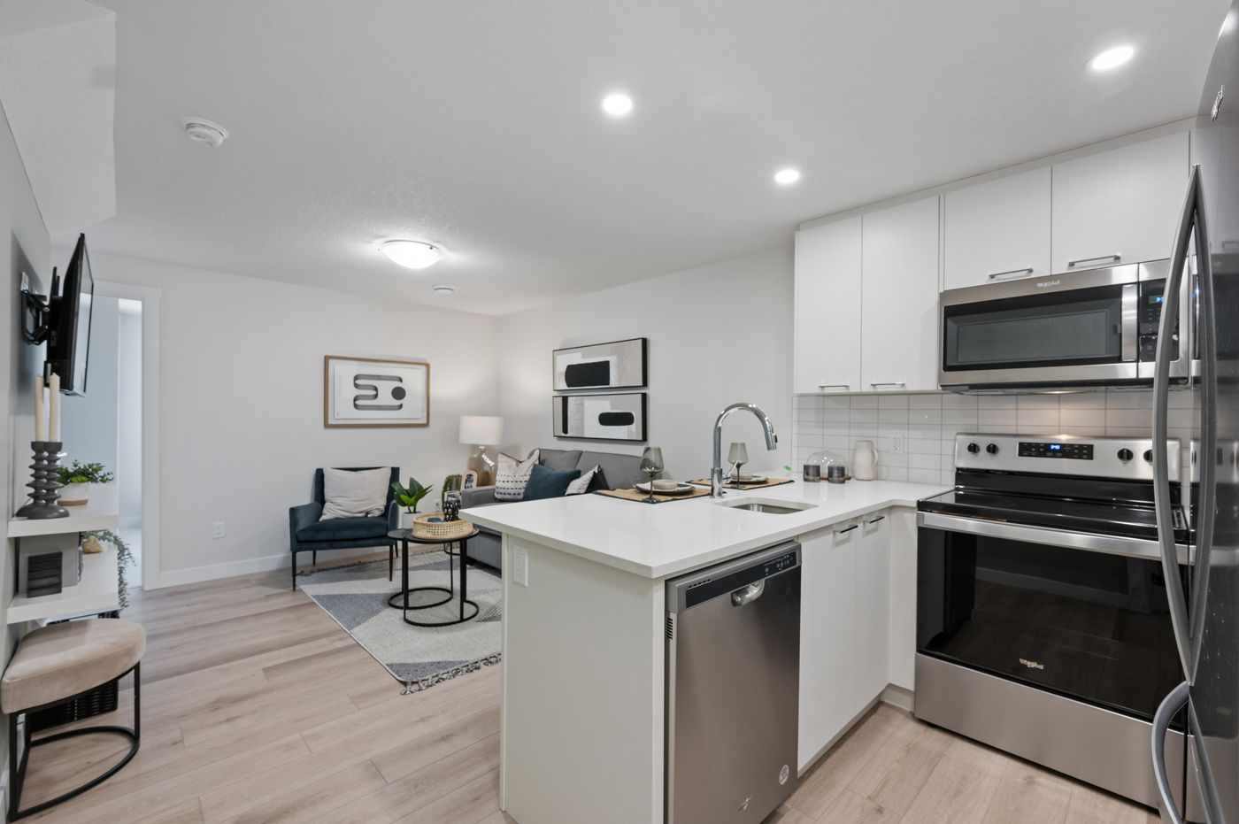 Open-concept kitchen and living room with stainless appliances